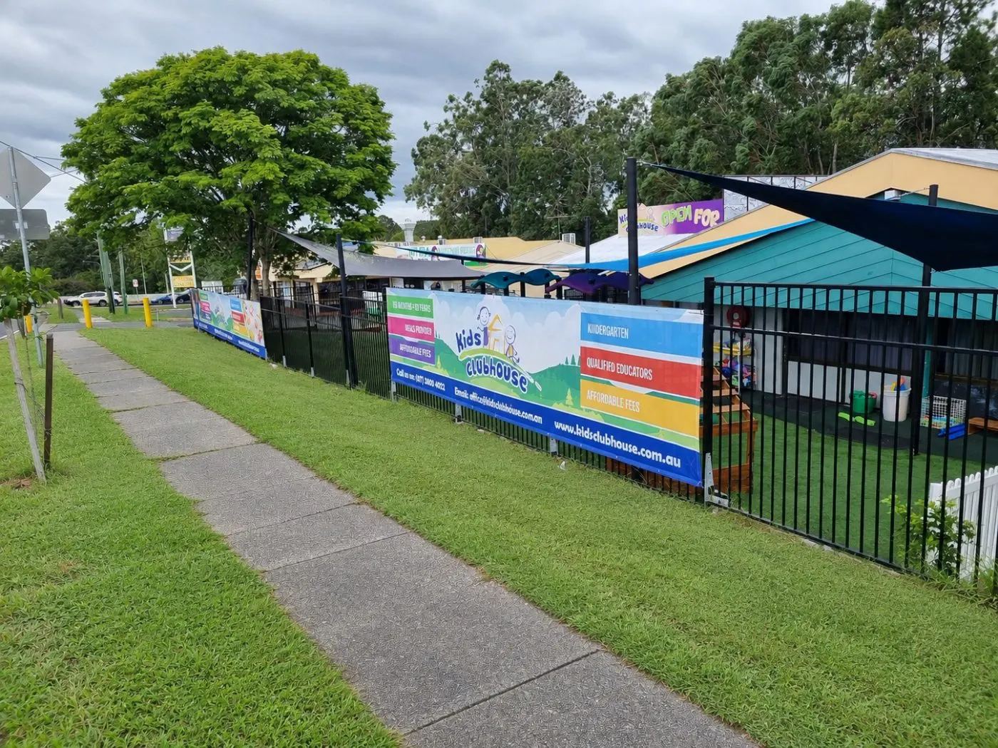 The front of Kids Clubhouse from the footpath, with our banners along the fence