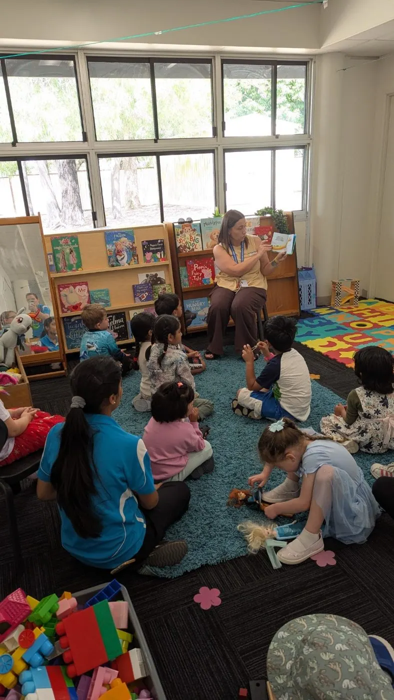 Children sitting on the mat during a story at a local school visit