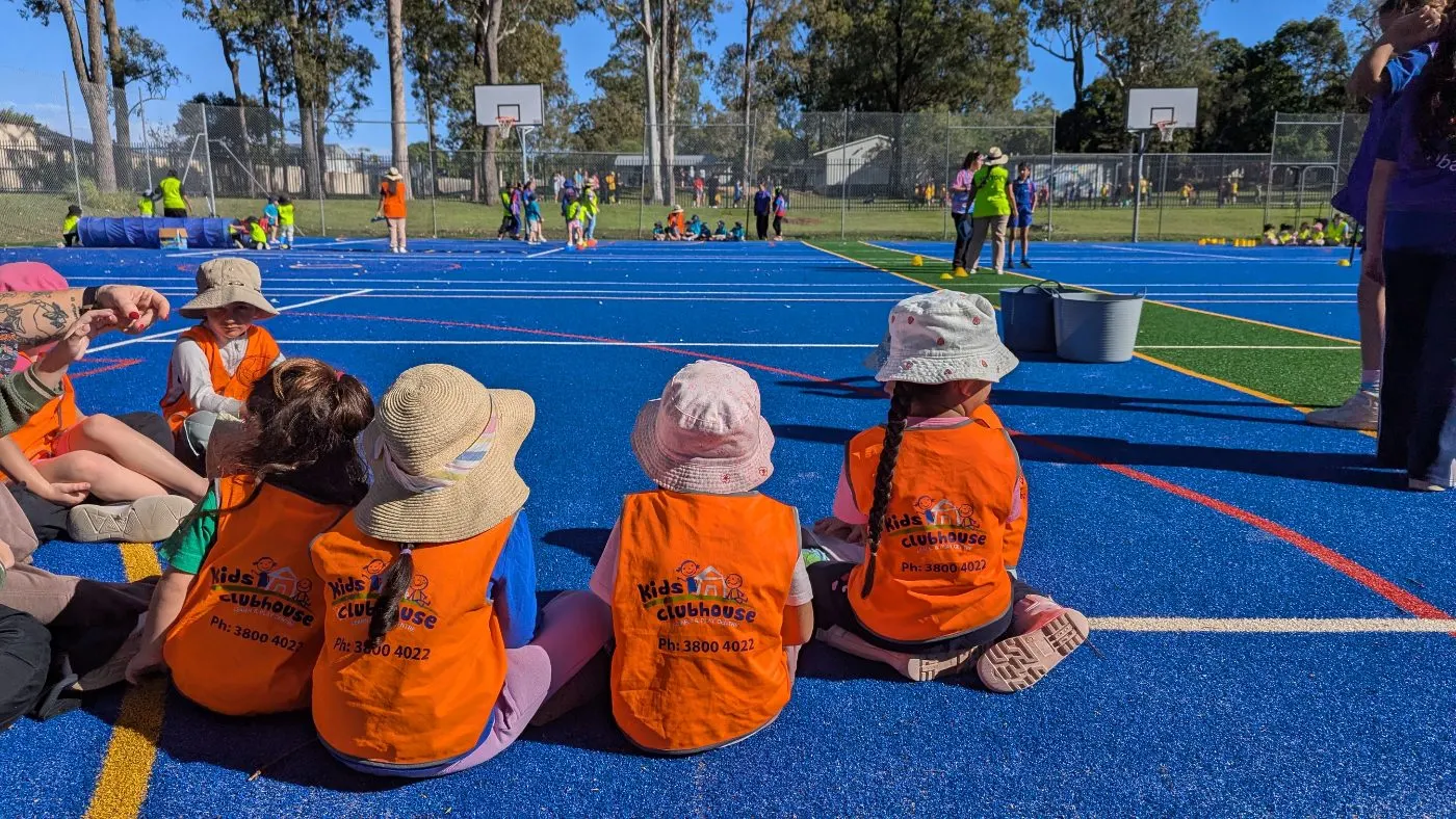 Children sitting together at a local sports morning