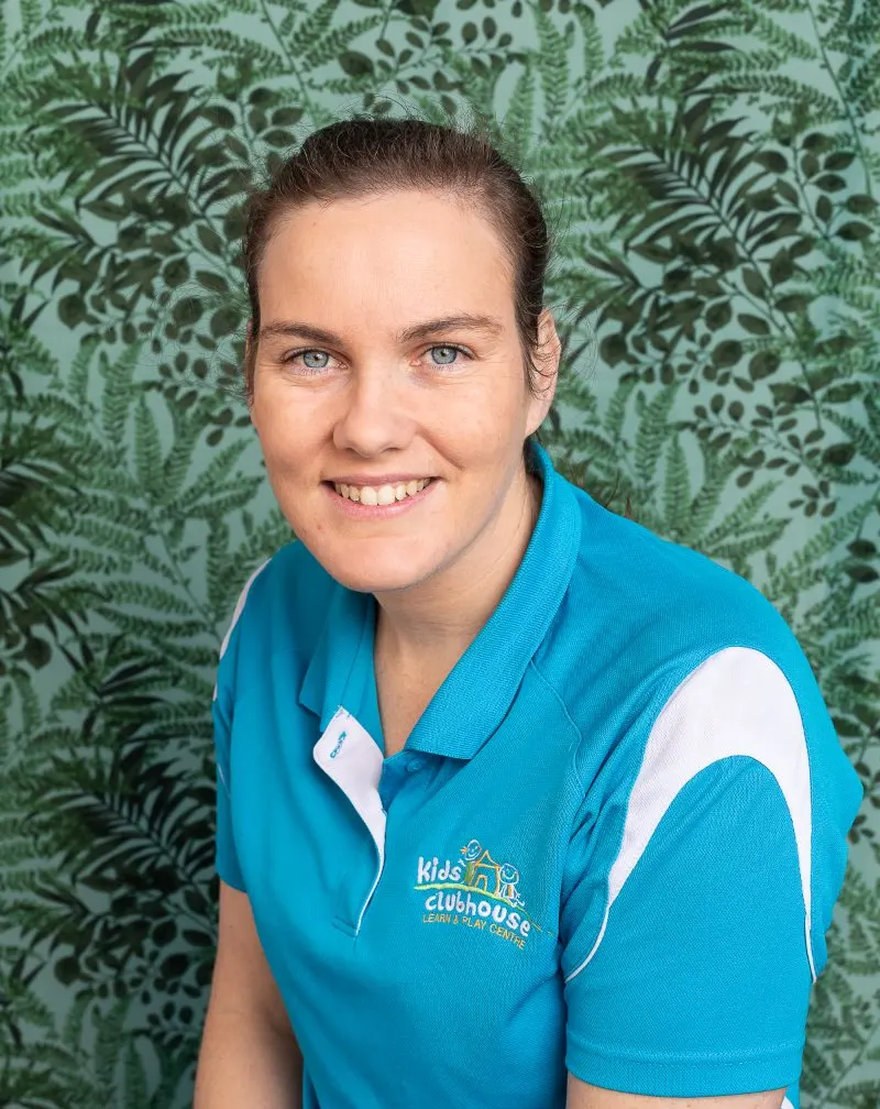 One of our educators smiling in her Kids Clubhouse polo